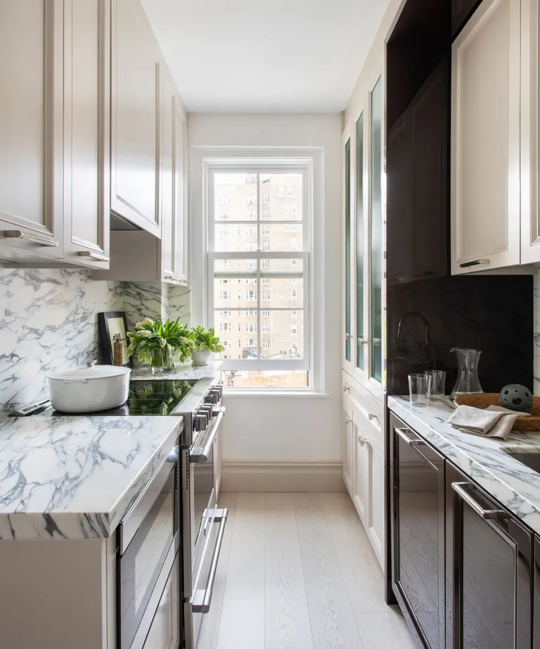 A Compact Galley Kitchen With Floor to Ceiling Cabinets